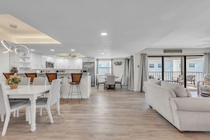 A modern interior with a dining area, kitchen, and living room.