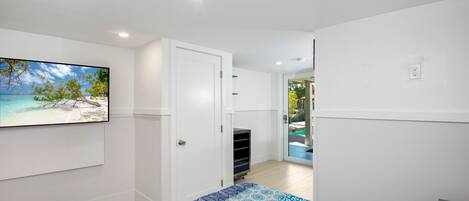 A bedroom with a bed, a wardrobe, and a door leading to a balcony.