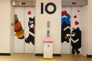 An elevator with two doors, each featuring a bear illustration. - Hey Bear Capsule Hotel (Xinbei Taipei Bridge Metro Station) (New Taipei City)