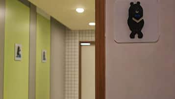 A hallway with a bear symbol on the wall, indicating a children's area.