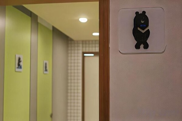 A hallway with a bear symbol on the wall, indicating a children's area. - Hey Bear Capsule Hotel (Xinbei Taipei Bridge Metro Station) (New Taipei City)
