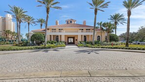 A building with a symmetrical facade, a central entrance, and a tiled roof. - Minorca Paros 402 (New Smyrna Beach)