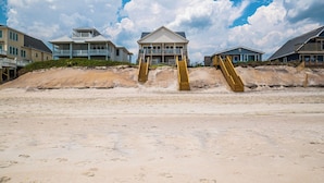 A beach house with a central building and two staircases leading up to it. - Hypnautical by Topsail Realty (Holly Ridge)