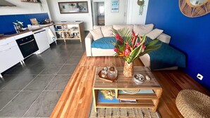 A modern living space with a kitchen, dining area, and a cozy seating area.