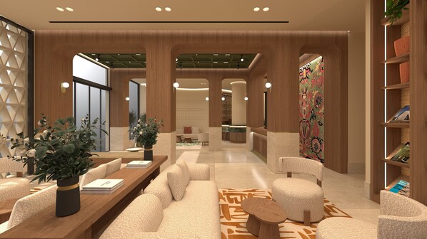 A modern hotel lobby with a long reception desk, comfortable seating, and a decorative wall.