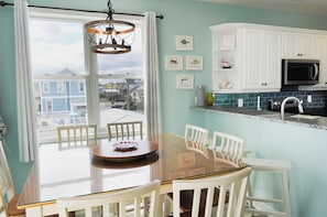 Enjoy meals in this cozy dining area with a glass-top table and comfortable seating for all.