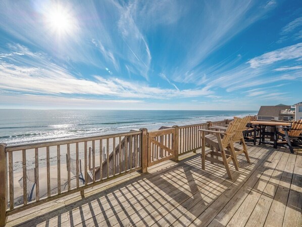 Enjoy ocean views from this outdoor space with a wooden deck, perfect for dining or relaxation.