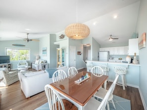 A spacious living room with a dining area, a kitchen, and a separate dining room. - Blue Haven by Topsail Realty (Holly Ridge)