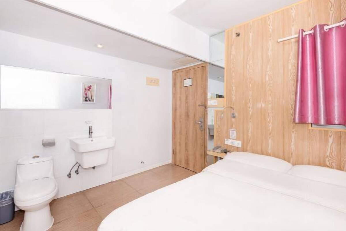 A modern bathroom with a toilet, sink, and shower area.