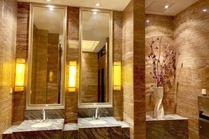 A bathroom with two sinks, large mirrors, and wall-mounted lights. - Yushan Hotel (Changshu)