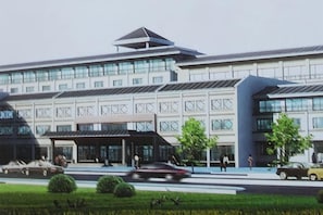 A modern building with a flat roof, large windows, and a covered entrance area. - Yushan Hotel (Changshu)