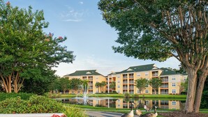 A hotel with a large building, a pond, and two geese on the pathway. - Sheraton Broadway Plantation/2BR-2BA/Labor Day Weekend 08/29 - 09/01 (Myrtle Beach)