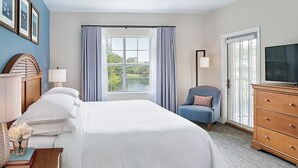 A hotel room with a large bed, a desk with a lamp, a chair, a dresser, and a TV. - Sheraton Broadway Plantation/2BR-2BA/Labor Day Weekend 08/29 - 09/01 (Myrtle Beach)