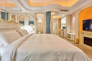 A spacious bedroom with a large bed, a television, and a fireplace. - Hangzhou Platinum Hanjue Hotel (Hangzhou)