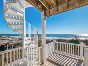A spiral staircase leading to a beach view, wooden deck, and white railings. - Sandy Feet by Topsail Realty (Sneads Ferry)