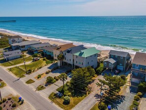 A coastal residential area with houses, a beach, and a pier. - Some Beach by Topsail Realty (Holly Ridge)
