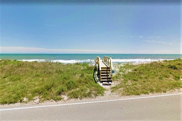 A beachside view with a wooden structure near the water's edge. - Sea Angels by Topsail Realty (Holly Ridge)