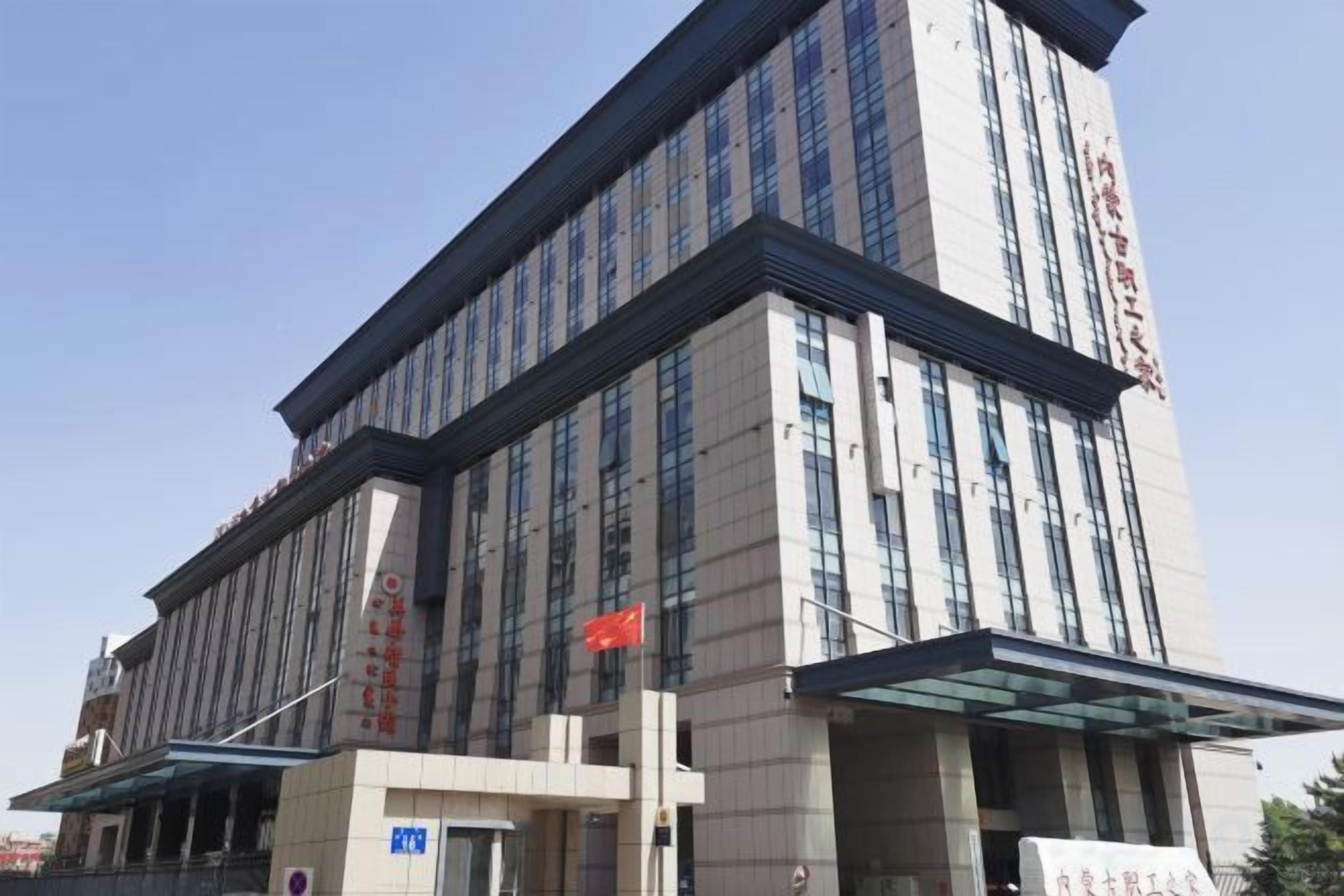 A multi-story hotel with a modern facade, large windows, and a prominent entrance.
