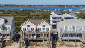 A beachfront property with multiple houses featuring balconies and direct beach access.