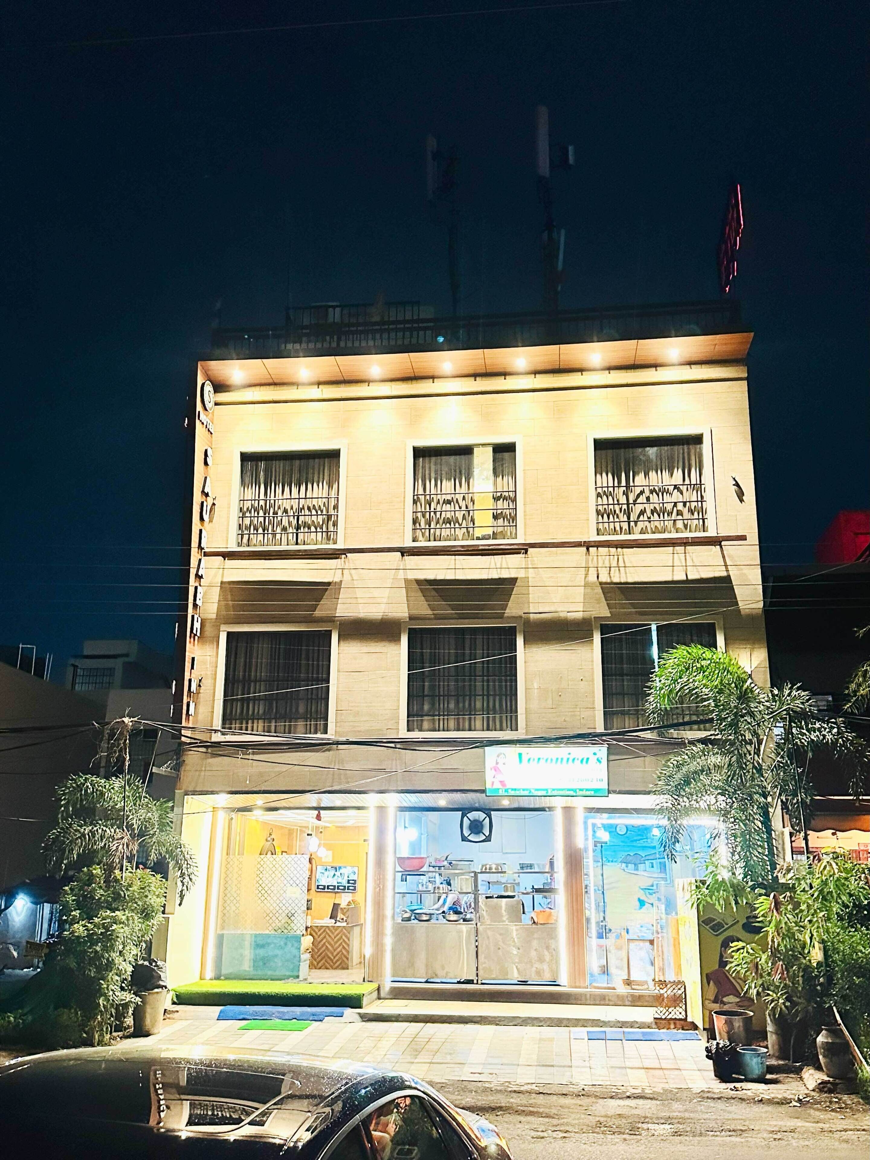 A building with a ground floor restaurant and upper residential units.