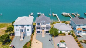A coastal property with multiple buildings, a marina with boats, and a clear view of the water. - Channel 6 by Topsail Realty (Holly Ridge)