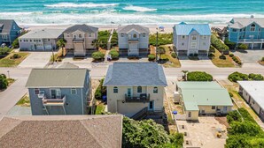 A coastal residential area with houses, a beach, and the ocean. - Perfectly Tangy by Topsail Realty (Holly Ridge)
