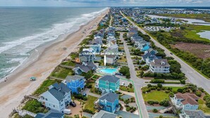 A coastal community with a beach, houses, and a community pool. - Summer Wynd by Topsail Realty (Sneads Ferry)