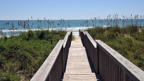 A wooden boardwalk leading to the beach with clear skies. - Summer Wynd by Topsail Realty (Sneads Ferry)