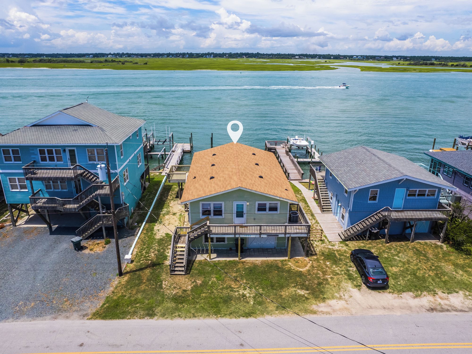 A coastal property with a dock, a boat, and a clear view of the water.