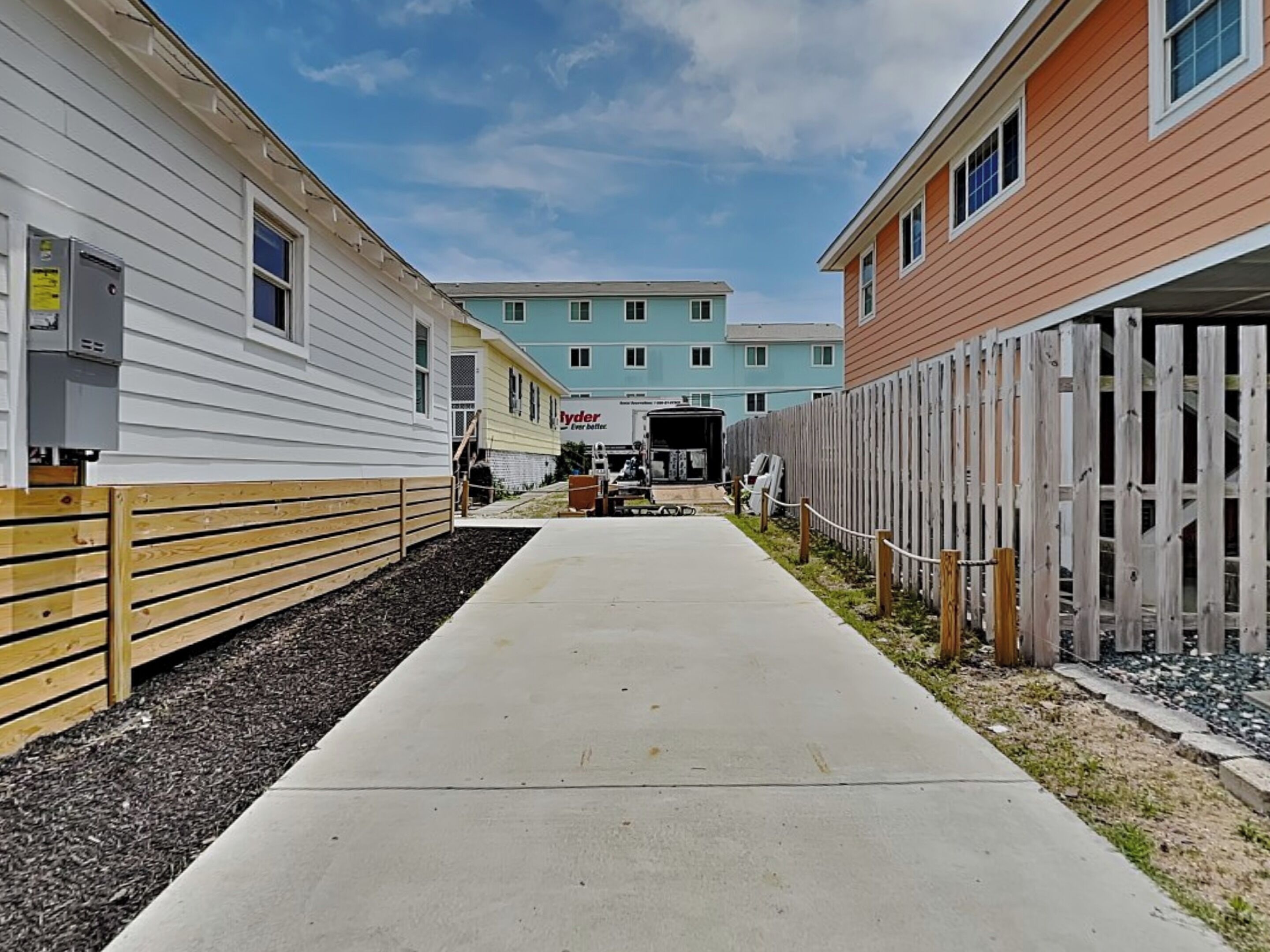 A pathway leading to a building with a sign that reads "Hyder Ever Better."