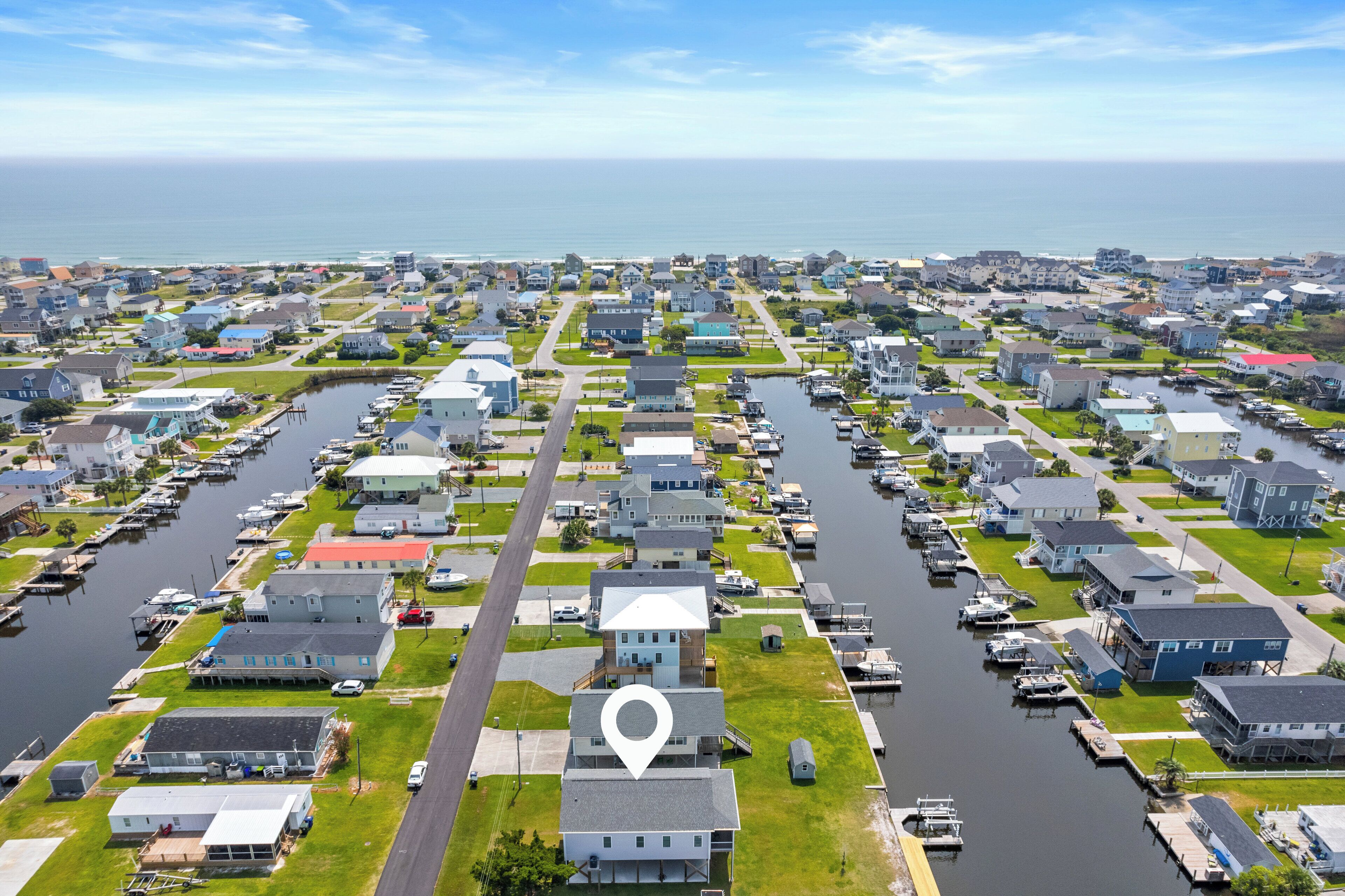 A residential area with houses, a marina, and a body of water.