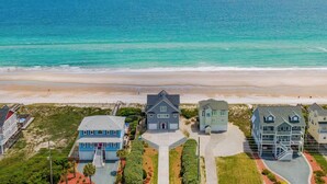 A coastal residential area with houses, a beach, and the ocean. - Topsail Escape by Topsail Realty (Sneads Ferry)