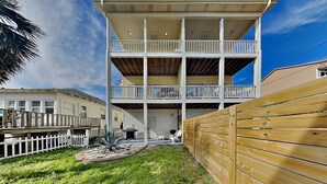 A multi-story building with a flat roof and a covered patio area. - Lucky Ducky by Carolina Retreats (Carolina Beach)