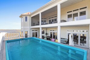 A two-story house with a swimming pool, balconies, and a covered patio area. - Permuda Private Island by Topsail Realty (Sneads Ferry)