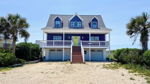 A two-story house with a front porch, a staircase, and a driveway. - Pelican Landing by Topsail Realty (Sneads Ferry)