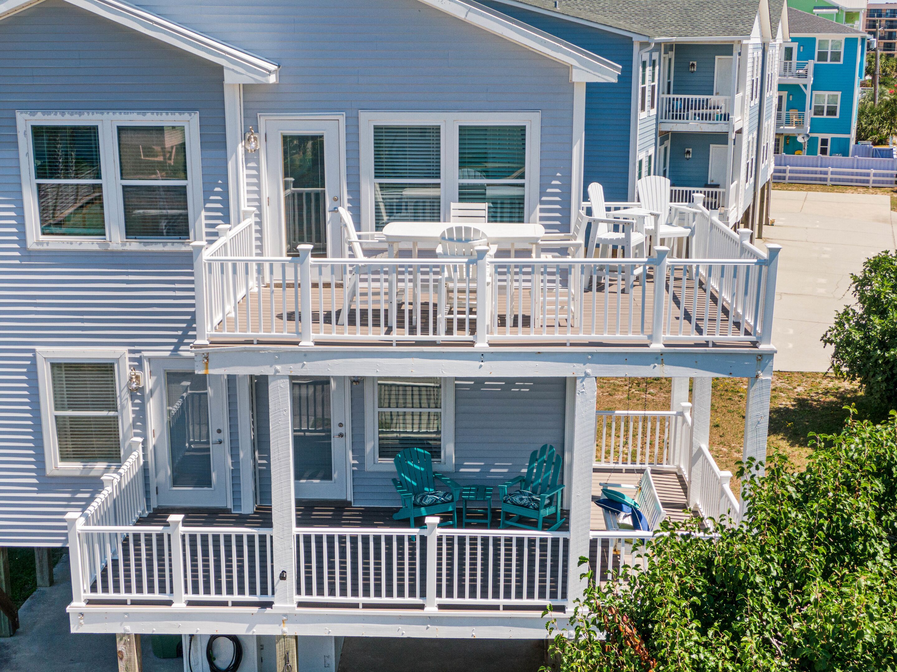 A two-story house with a balcony and a deck.