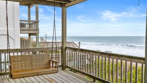 A wooden deck with a swing, a bench, and a view of the ocean. - Renegade by Topsail Realty (Holly Ridge)