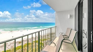 A balcony with a view of a beach and ocean. - Edgewater Tower 2-608 (Panama City Beach)