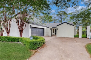 Single-family home with a well-manicured yard and a porch area.