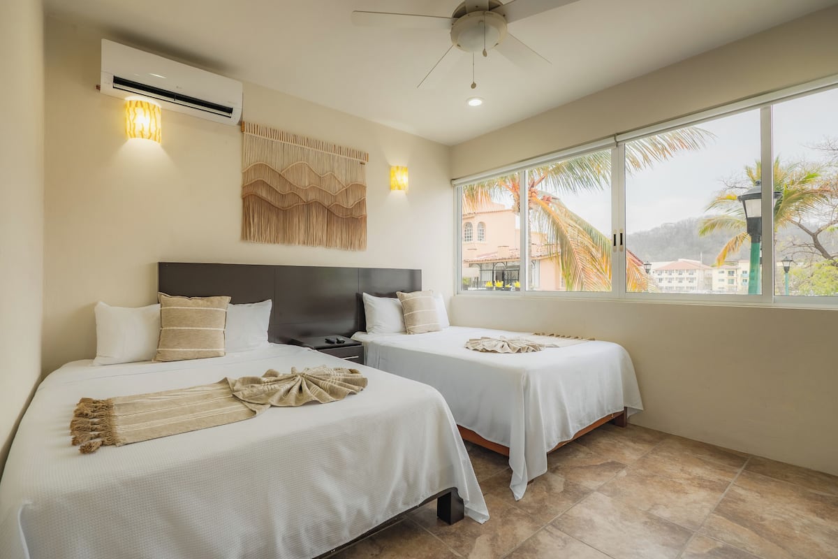 Suite, 2 Double Beds, City View | 1 bedroom, in-room safe, laptop workspace, blackout curtains