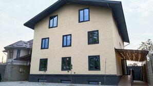 A multi-story building with a flat roof and a series of windows. - Pristine Hotel (Bishkek)