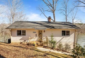 A single-story house with a front porch, a chimney, and a small front yard. - Homestead on Hyco - 21 Min to VIR (Semora)