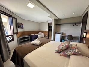 Family Triple Room, Garden View | Minibar, laptop workspace, blackout drapes, iron/ironing board