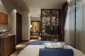 A hotel room with a bed, a TV, a wooden cabinet, and a decorative screen. - Luzhou Weiyi Hotel (Luzhou)