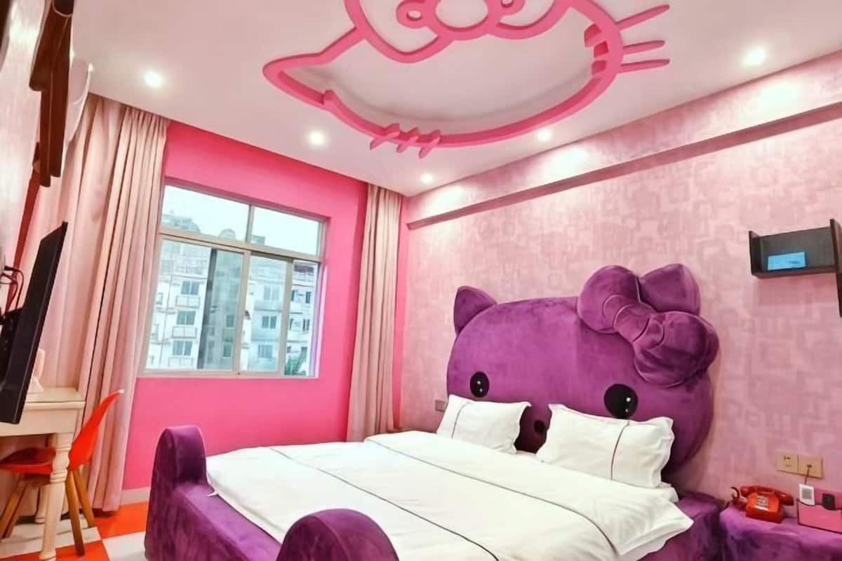 A room with a bed, a desk, a chair, a window, and a television.