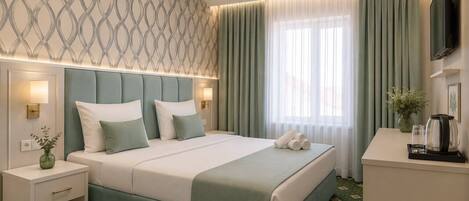 A modern hotel room with a large bed, bedside tables, a flat-screen TV, and a window with curtains.