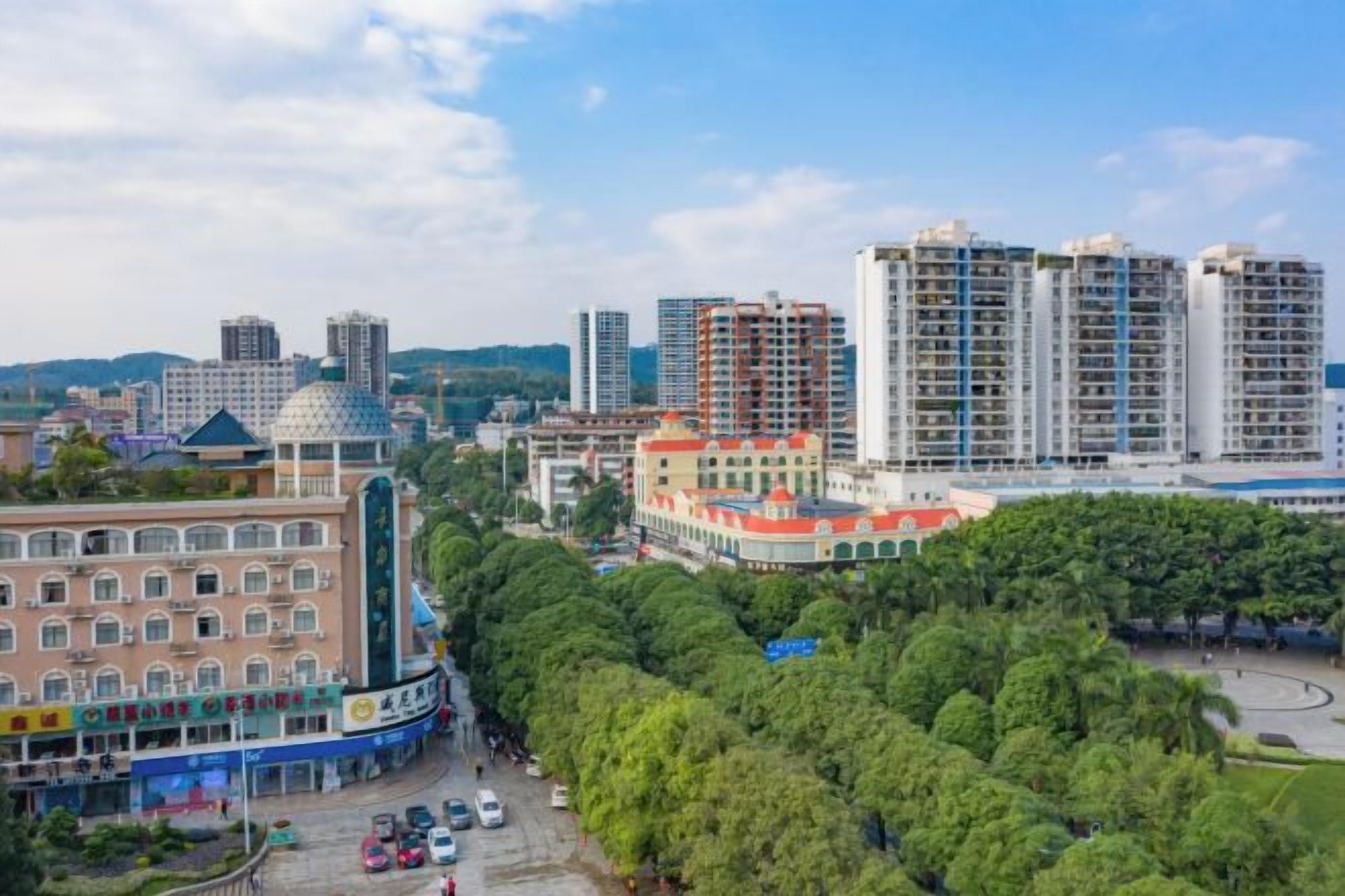 A cityscape with high-rise buildings, a green park, and a building with a dome.