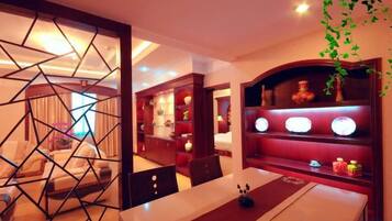 A dining area with a table, chairs, and a decorative partition.