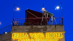 A building with a sign reading "Bella Vista Hotel Cafe & Breakfast". - Bellavista Stone House (Urgup)