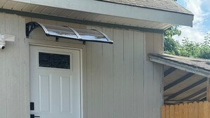 A white door with a small porch and steps leading up to it. - Comfortable and Spacious Home close to OSU Campus (Stillwater)